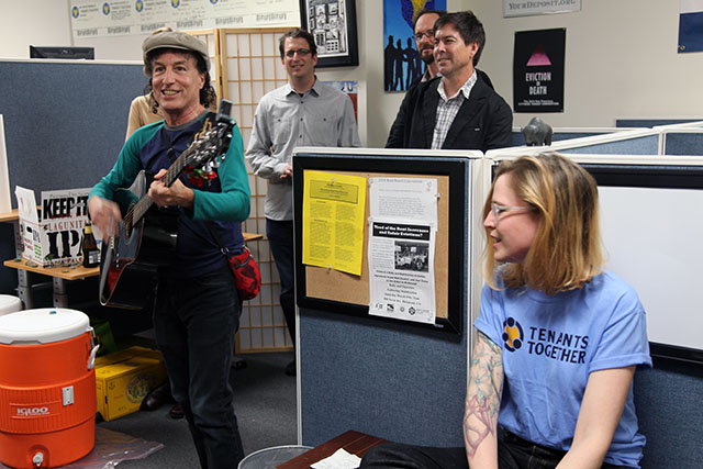 Tenants Together's new office warming party included beer, hummus, and a performance by Tommi Avicolli Mecca of the Housing Rights Committee. Photo by Laura Waxmann