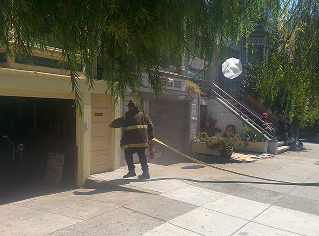 Firefighters are going in through the back on 115 Bartlett Street. Photo by Laura Wenus