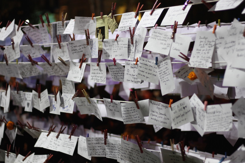 By late evening, notes to departed loved ones had filled the installation.
